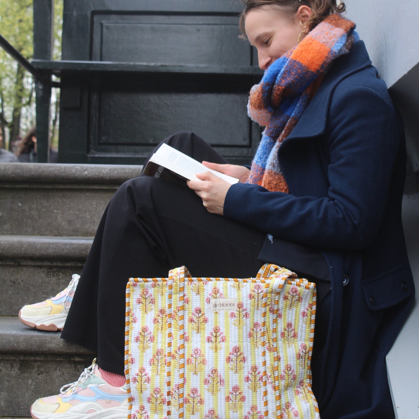 yellow tote bag on steps with a book