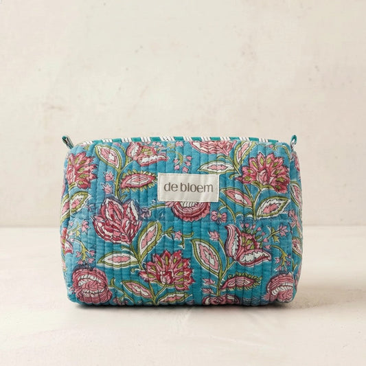 Floral patterned pouch with 'de bloem' label on a beige background