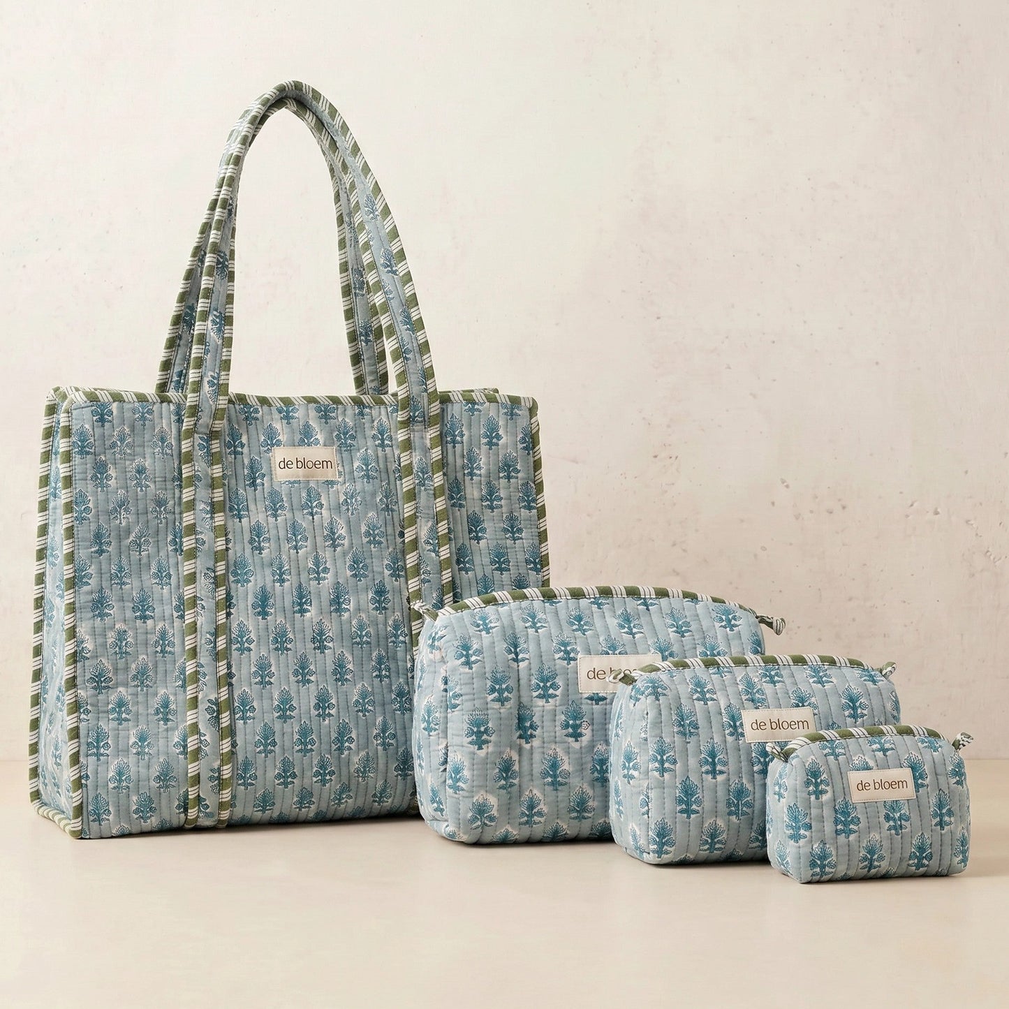 Set of blue patterned bags with visible brand name on a light background