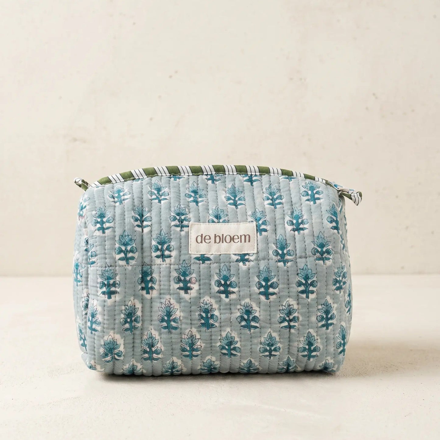 Small fabric pouch with tree pattern on a beige background