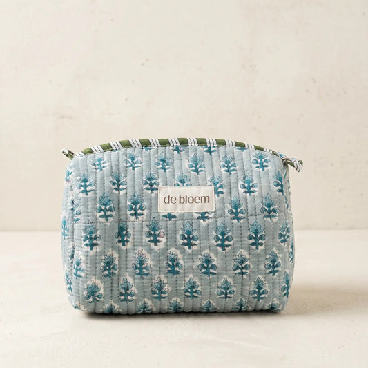Small fabric pouch with tree pattern on a beige background