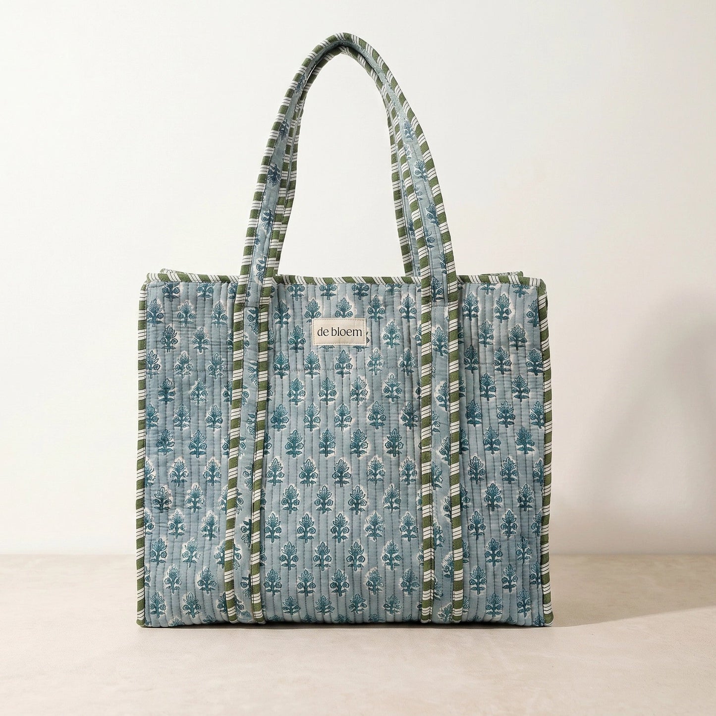 Patterned tote bag with visible brand name on a plain background