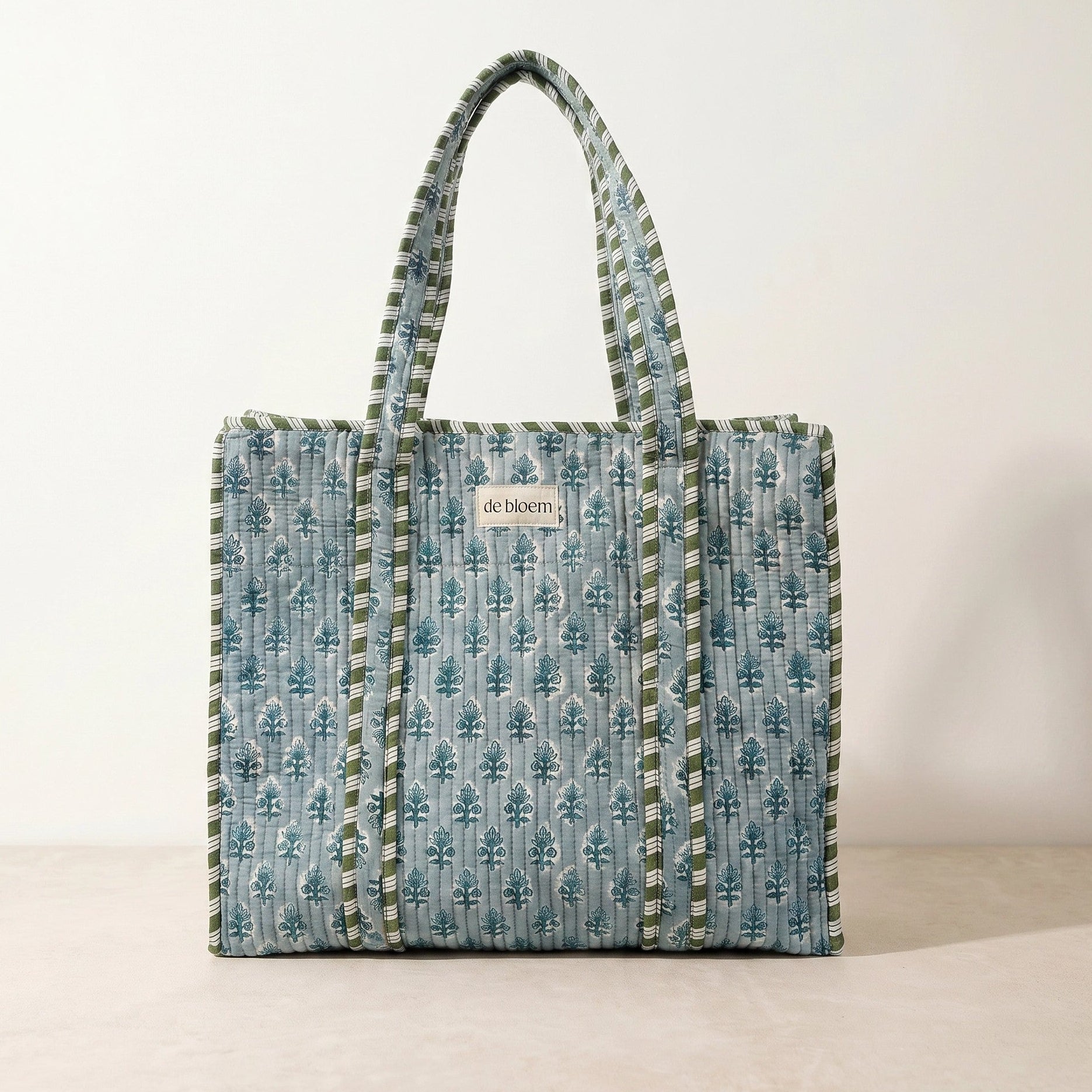 Patterned tote bag with visible brand name on a plain background