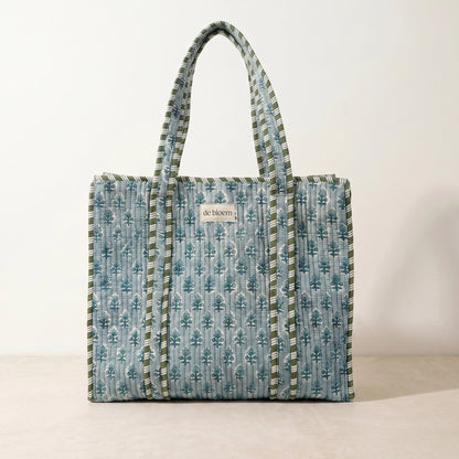 Patterned tote bag with visible brand name on a plain background