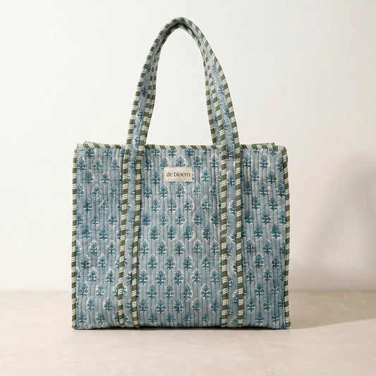 Patterned tote bag with visible brand name on a plain background