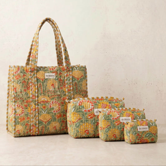 Set of floral-patterned bags including a large tote and three smaller pouches on a light background.