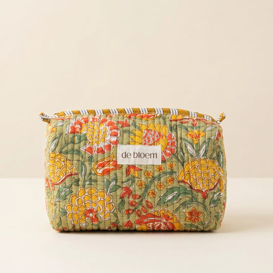 Floral-patterned pouch with 'de bloem' label on a beige background