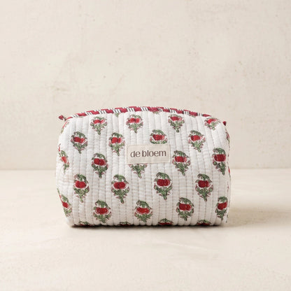 Fabric pouch with floral pattern and 'de bloem' branding on a beige background