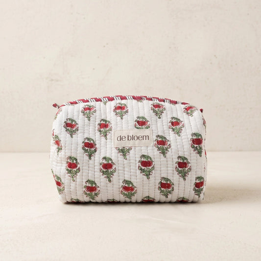 Fabric pouch with floral pattern and 'de bloem' branding on a beige background