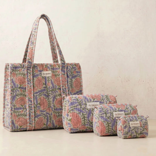 Set of floral-patterned bags including a tote and three pouches on a light background