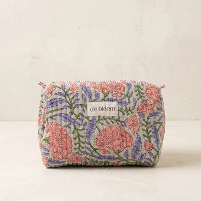 Floral-patterned pouch with 'de bloem' branding on a beige background