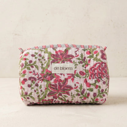 Floral-patterned pouch with 'de bloem' label on a light background