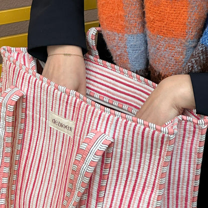 woman opening up a tote bag
