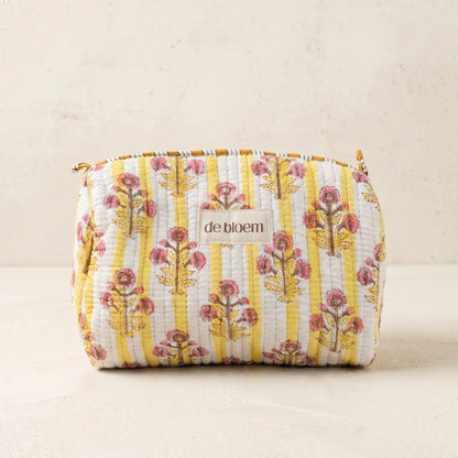 Floral patterned pouch with 'de bloem' branding on a beige background