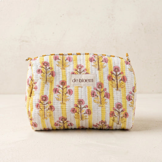 Floral patterned pouch with 'de bloem' branding on a beige background