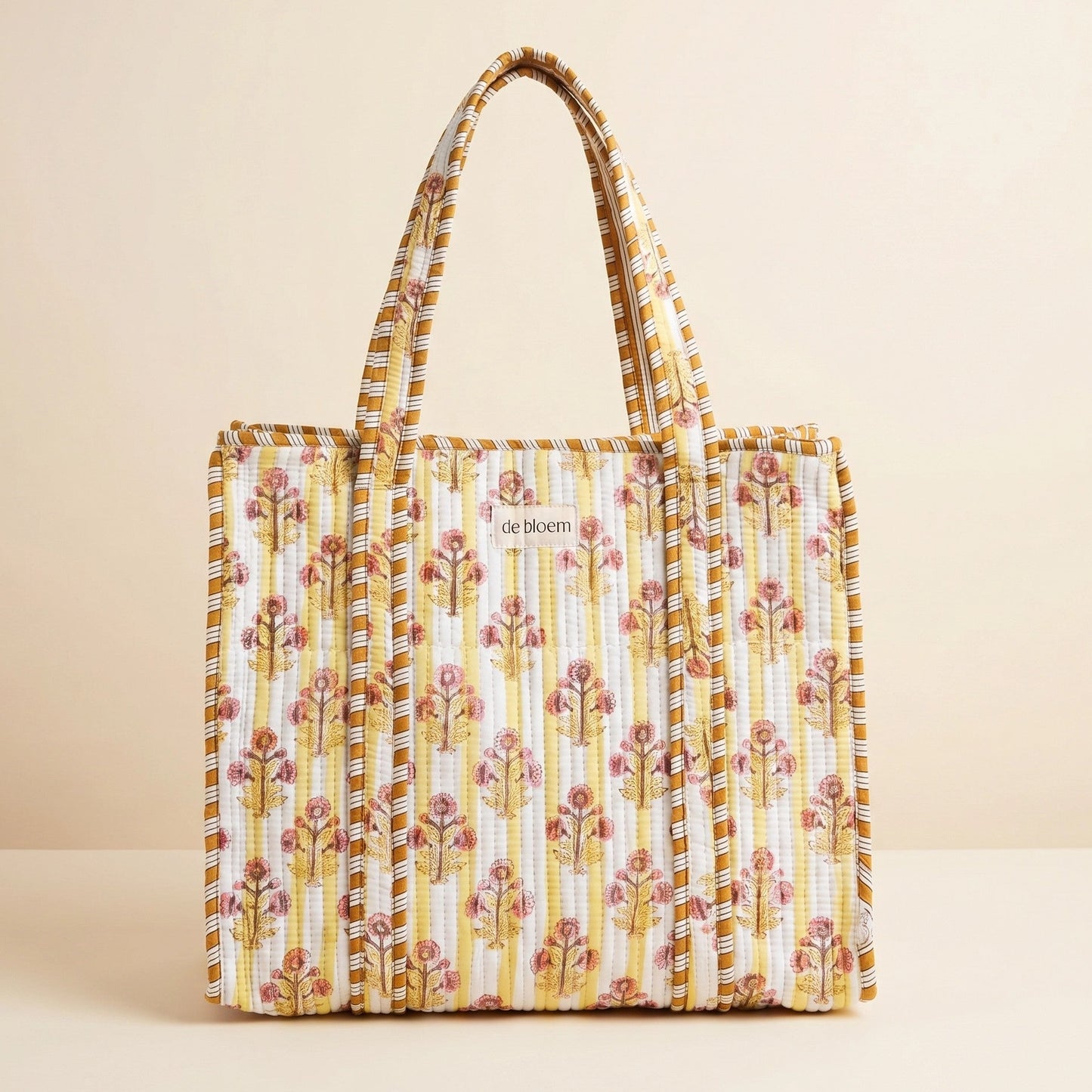 Yellow Floral patterned tote bag on a beige background