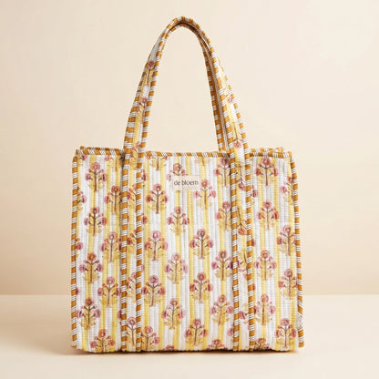 Yellow Floral patterned tote bag on a beige background
