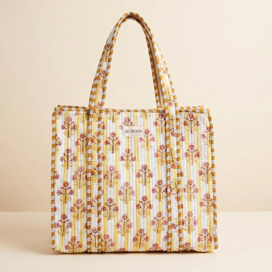 Yellow Floral patterned tote bag on a beige background