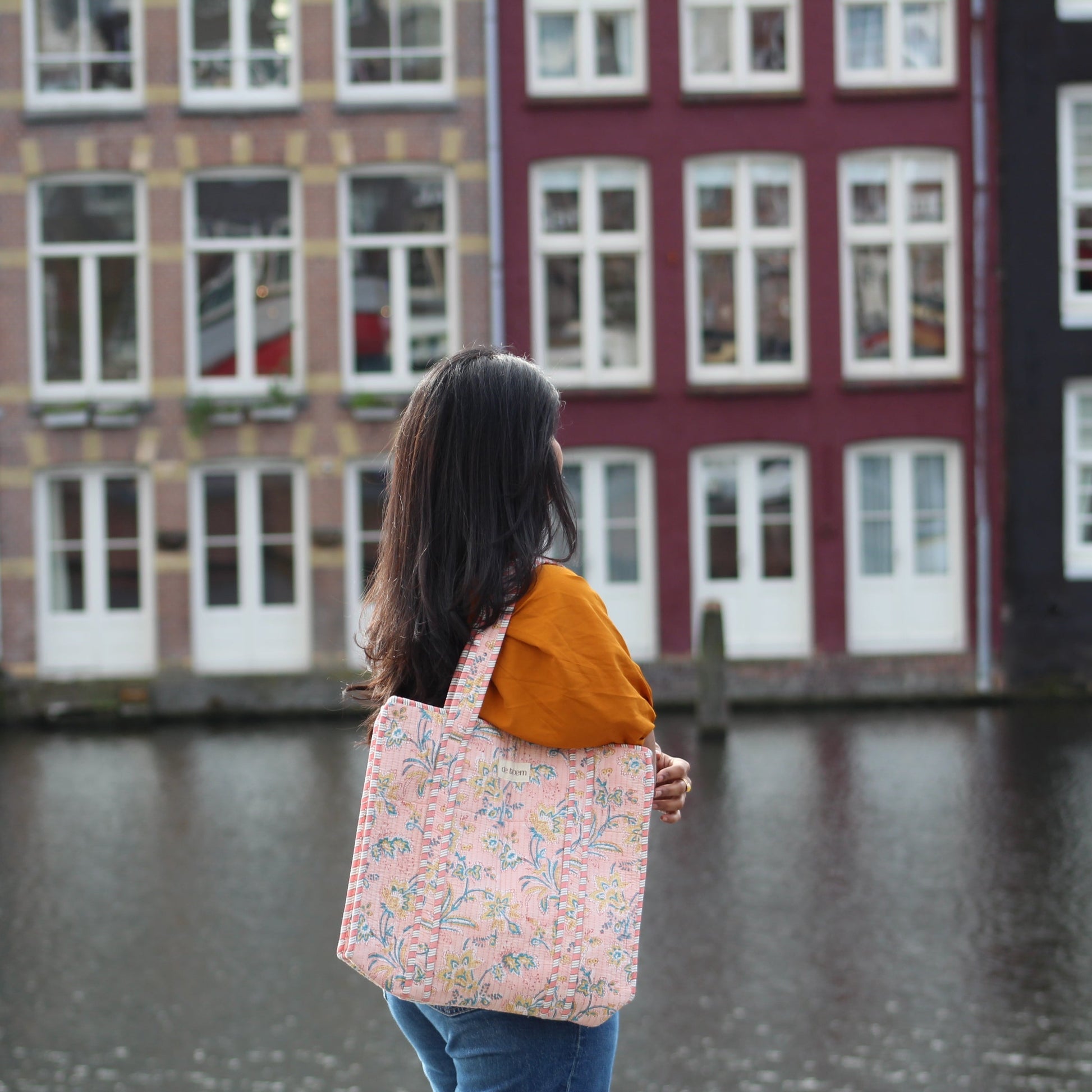 lily bag (tote) being held in front of dutch houses